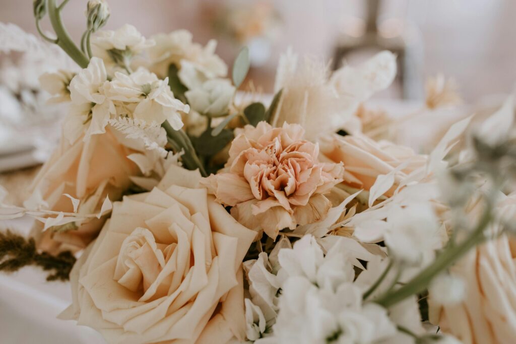 Bouquet of soft peach and white roses with delicate greenery, symbolizing romance and elegance for weddings in Las Vegas.